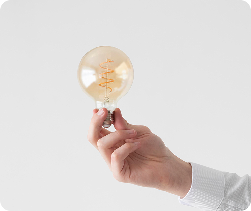 close-up-hand-holding-light-bulb-with-copy-space 1